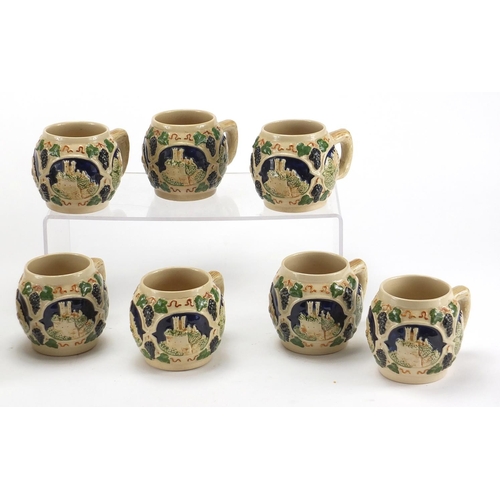 578 - German twin handled pottery server with eight cups, each decorated with various German views, the la... 