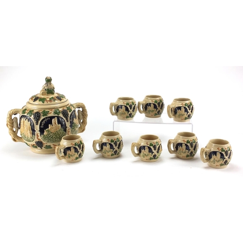 578 - German twin handled pottery server with eight cups, each decorated with various German views, the la... 