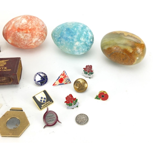 388 - Bag of objects including polished stone eggs, enamelled badges and matchbox cases