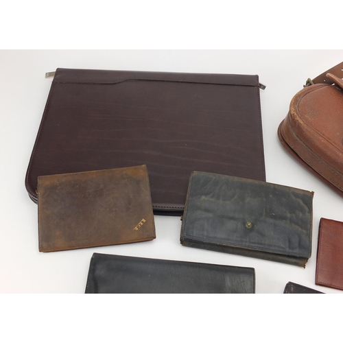 710 - Vintage leather holdall and a group of leather wallets