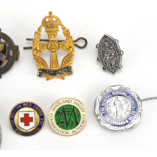 352 - Nine Nursing Association brooches, some enamelled