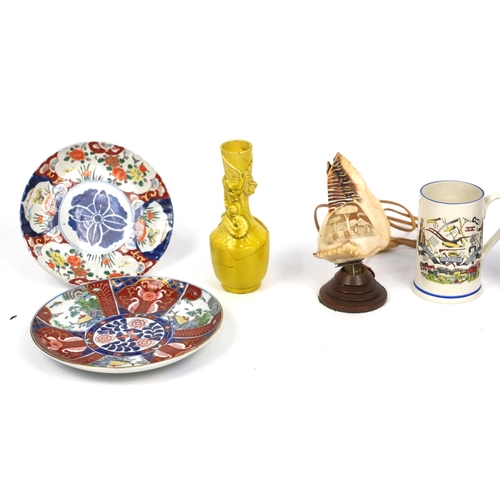 411 - Assorted china including an antique tin glazed barbers bowl, Imari pattern plates and a conch shell ... 