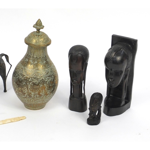 511 - Middle Eastern and African items including ebony busts, brass vase and cover and a bronzed bust