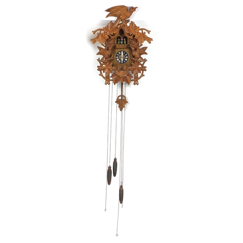 2039 - Black forest cuckoo clock, carved with leaves and birds, with weights and pendulum, 48cm high