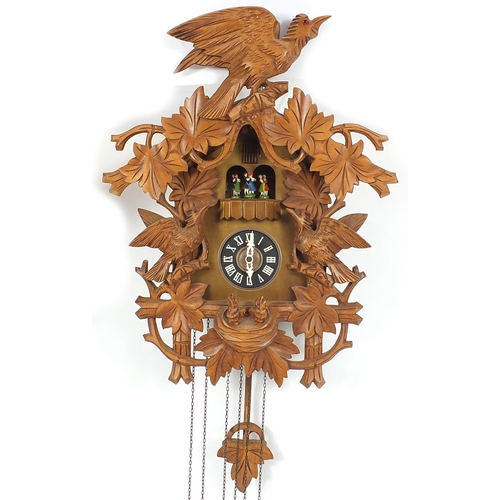 2039 - Black forest cuckoo clock, carved with leaves and birds, with weights and pendulum, 48cm high