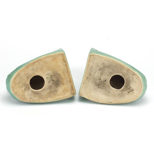 2166 - Pair of Langley green glazed pottery bookends, both of dolphin form and with factory marks to the ba... 