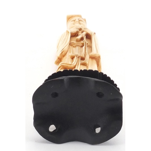 2301 - Chinese carved ivory okimono of a gentleman holding a scroll, on hardwood stand, 22cm high