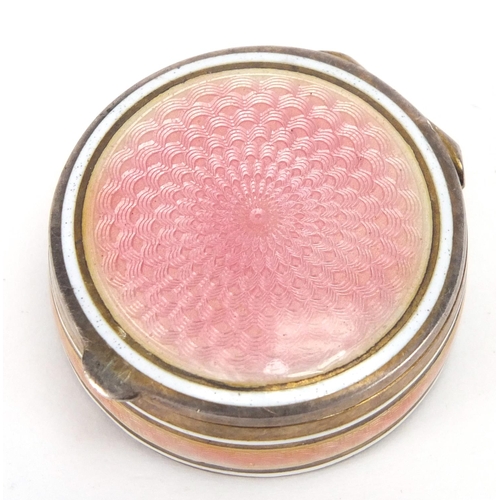 2303 - Circular continental 835 silver and pink guilloche enamel pill box, with hinged lid and gilt interio... 