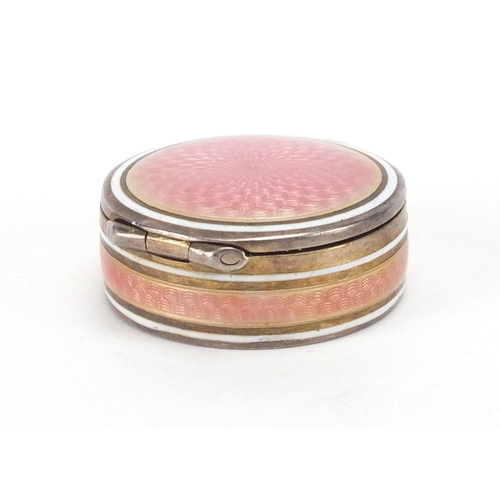 2303 - Circular continental 835 silver and pink guilloche enamel pill box, with hinged lid and gilt interio... 