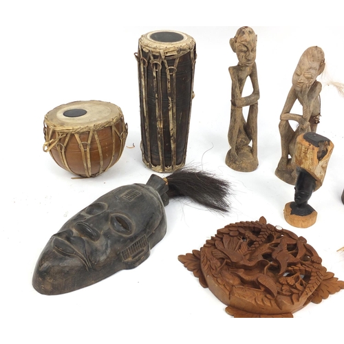 516 - Group of Tribal wood carvings, face masks and two drums