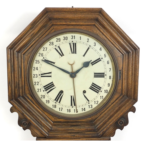 81 - Octagonal oak cased drop dial calendar wall clock with Roman numerals, 85cm high