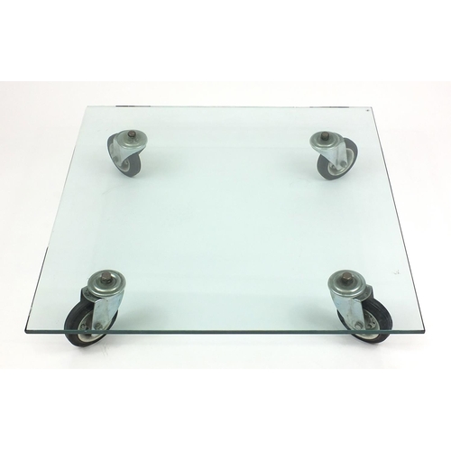 98 - Heavy industrial style glass coffee table on wheels, 20cm H x 100cm W x 100cm D