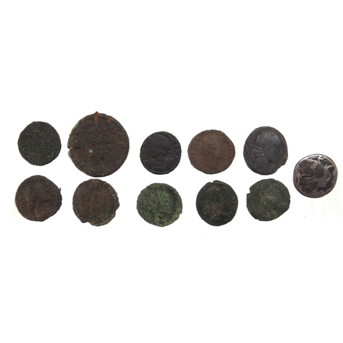 451 - Elven Roman coins including a silver example, approximate weight 34.1g