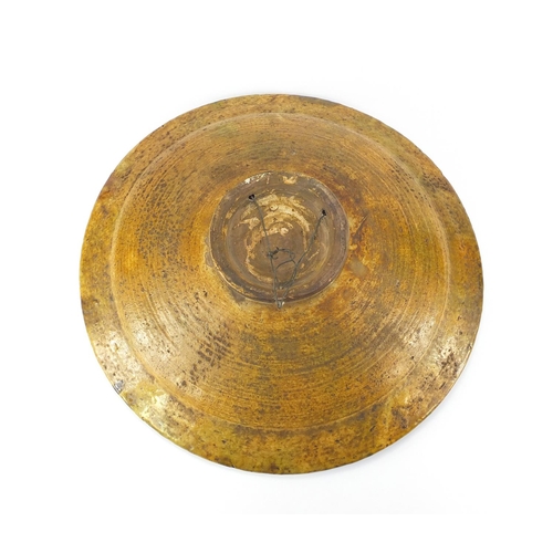 470 - Large Victorian treacle glazed pottery charger, 44cm in diameter