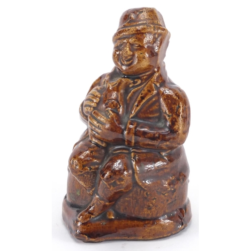 479 - 19th Century treacle glazed pottery money box in the form of a toby jug, impressed 'Money Taken Here... 