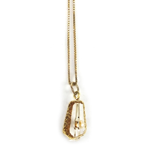 252 - Gold coloured metal and pearl pendant on a gold coloured metal necklace