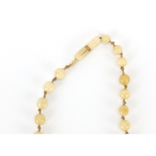 289 - Two antique Chinese ivory necklaces, the largest bead 1.8cm in diameter, approximate weight 160.0g