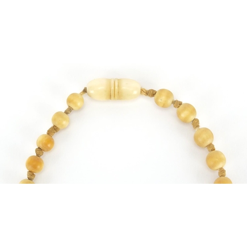 289 - Two antique Chinese ivory necklaces, the largest bead 1.8cm in diameter, approximate weight 160.0g