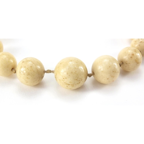 289 - Two antique Chinese ivory necklaces, the largest bead 1.8cm in diameter, approximate weight 160.0g