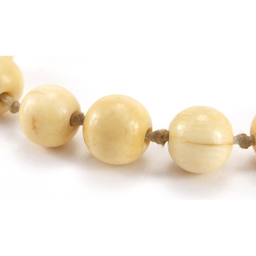 289 - Two antique Chinese ivory necklaces, the largest bead 1.8cm in diameter, approximate weight 160.0g