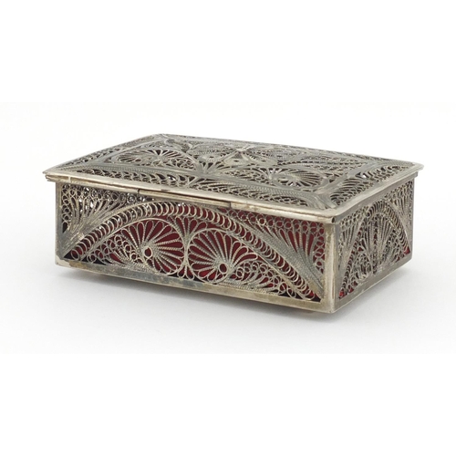 329 - Unmarked filigree silver coloured metal box with hinged lid, 11.5cm in length