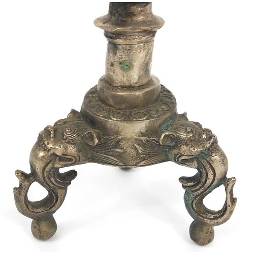 551 - Oriental Chinese silver metal candlestick, decorated with dragons, character mark to base, 40cm high