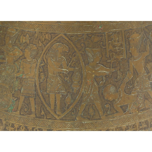 597 - Egyptian brass pot together with a large tray,  both profusely engraved with figures, the tray 70cm ... 