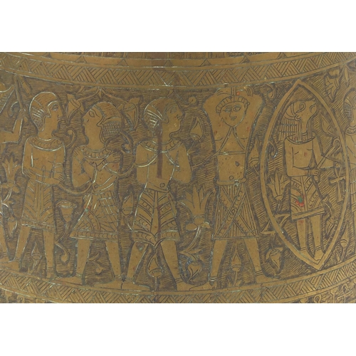 597 - Egyptian brass pot together with a large tray,  both profusely engraved with figures, the tray 70cm ... 