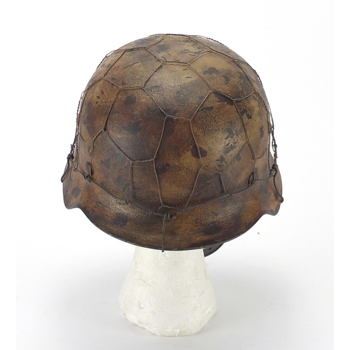 718 - German Military interest style helmet with chicken wire and chin strap, impressed 1939