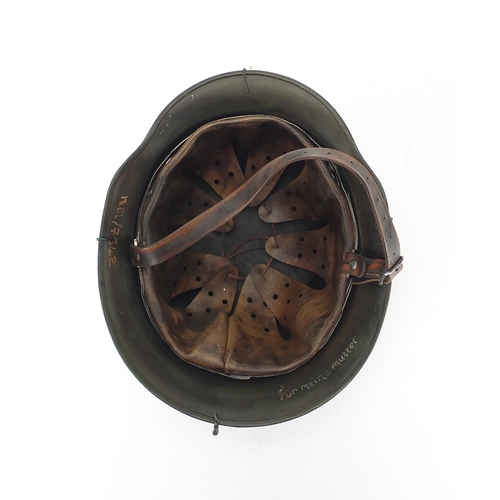 718 - German Military interest style helmet with chicken wire and chin strap, impressed 1939