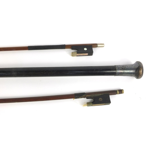 562 - Ebonized walking cane with silver collar and two violin bows, one with Mother of Pearl inlay