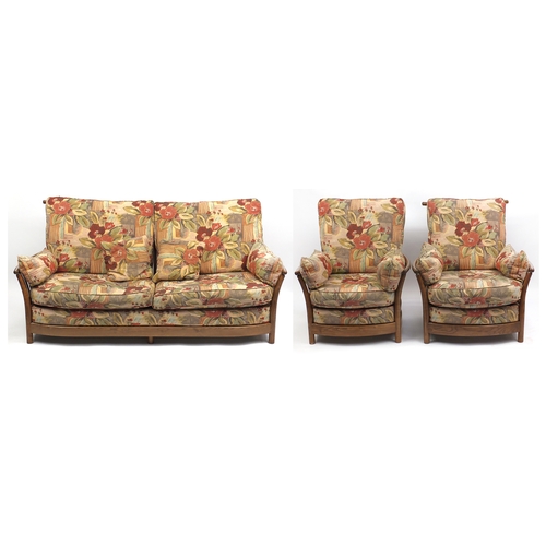2019a - Ercol elm three piece suite, comprising a three seat settee and a pair of arm chairs, each with loos... 