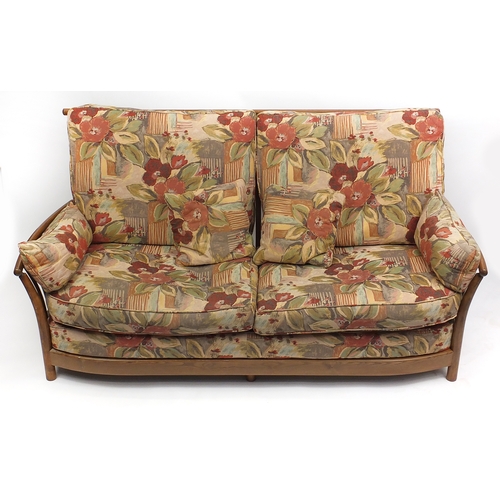 2019a - Ercol elm three piece suite, comprising a three seat settee and a pair of arm chairs, each with loos... 