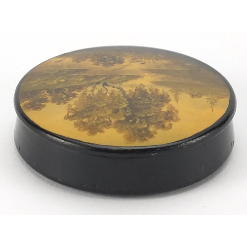 19 - Russian lacquered snuff box, the lid hand panted with a river, indistinctly titled and inscribed to ... 