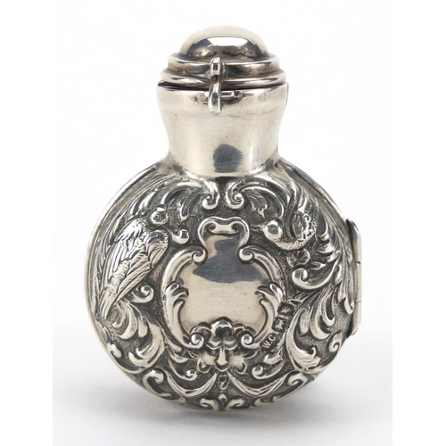 40 - Miniature silver cased green glass scent bottle by William Comyns, the case embossed with birds and ... 