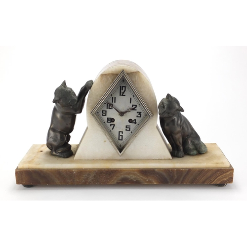 601 - Art Deco marble and onyx  mantel clock, mounted with two bronzed cats, the silvered dial with Arabic... 