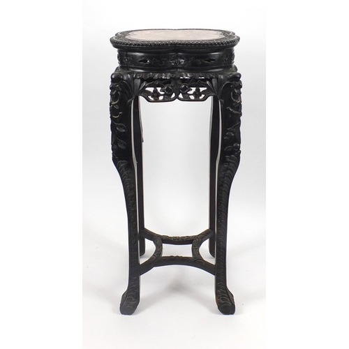 392 - Chinese hardwood plant stand with inset marble top, carved with flower heads and berries, 92.5cm hig... 