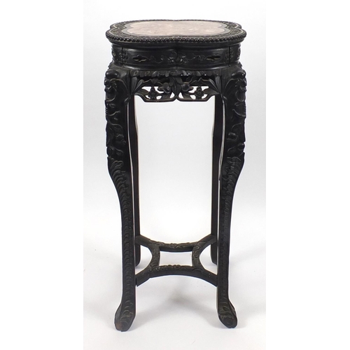 392 - Chinese hardwood plant stand with inset marble top, carved with flower heads and berries, 92.5cm hig... 