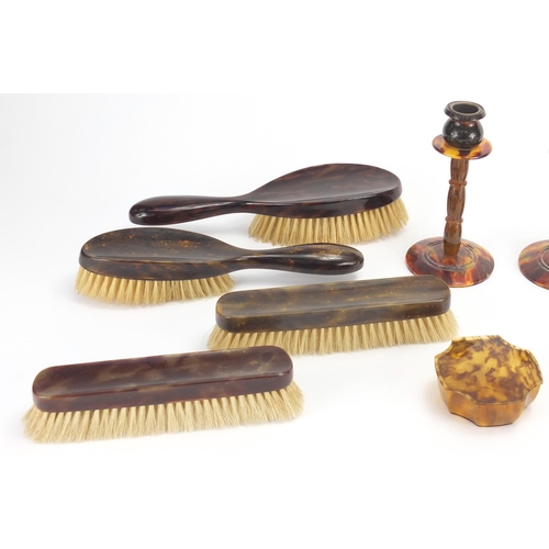 65 - Collection of faux tortoiseshell including hand brushes, pair of candlesticks and a strut clock, the... 