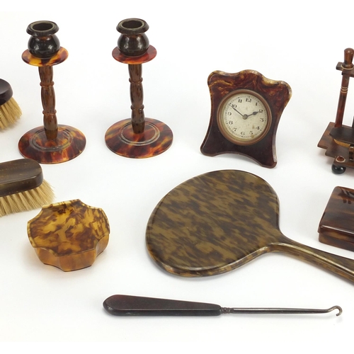 65 - Collection of faux tortoiseshell including hand brushes, pair of candlesticks and a strut clock, the... 