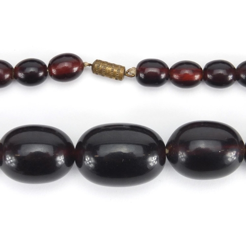 785 - Three cherry amber coloured bead necklaces, the largest 50cm in length, approximate weight 143.0g