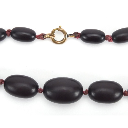 785 - Three cherry amber coloured bead necklaces, the largest 50cm in length, approximate weight 143.0g