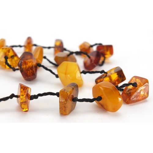 783 - Two natural amber coloured necklaces and a cheroot, approximate weight 88.0g