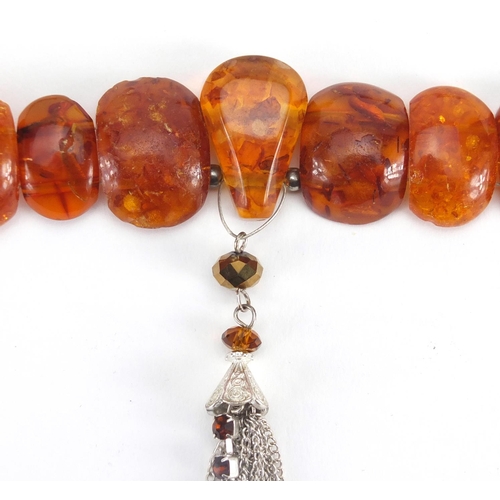 783 - Two natural amber coloured necklaces and a cheroot, approximate weight 88.0g