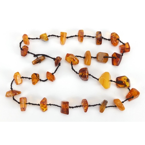 783 - Two natural amber coloured necklaces and a cheroot, approximate weight 88.0g