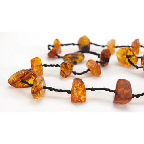 783 - Two natural amber coloured necklaces and a cheroot, approximate weight 88.0g