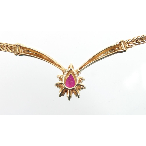 719 - 14ct gold tear drop ruby and diamond necklace, 24cm in length, housed in a Christian Bernard of Pari... 