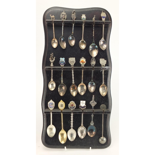 532 - Collection of silver plated souvenir teaspoons, with two display stands