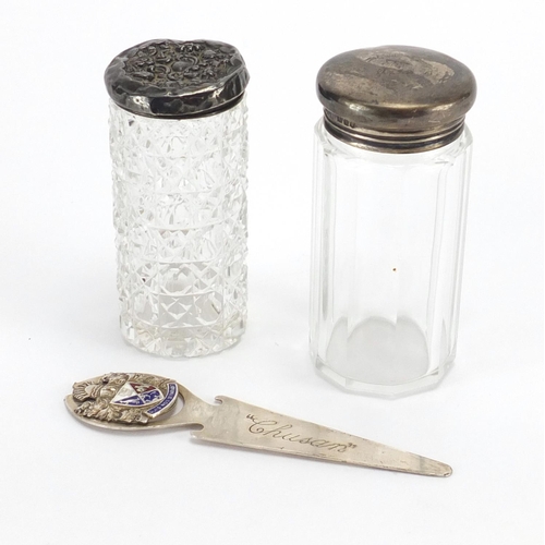 537 - Silver page marker with enamelled crest and two cut glass bottles with silver lids, the largest 8.5c... 