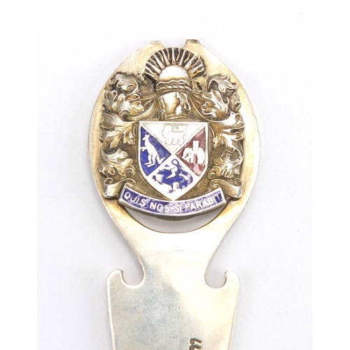 537 - Silver page marker with enamelled crest and two cut glass bottles with silver lids, the largest 8.5c... 